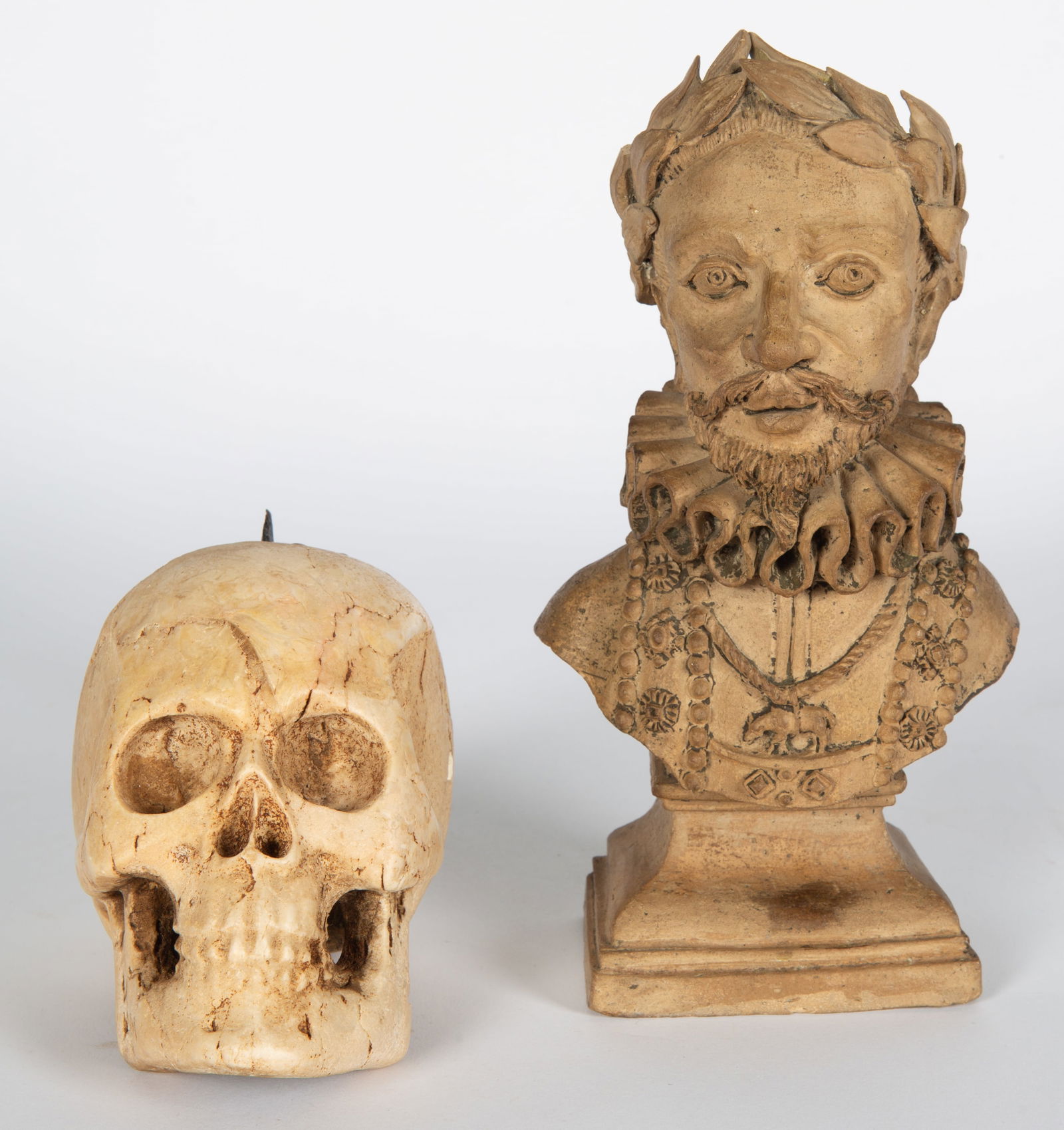 A PAIR OF CARVED STONE FIGURES: TERRACOTTA BUST OF A MAN AND SKULL CANDLESTICK? (1 of 5)