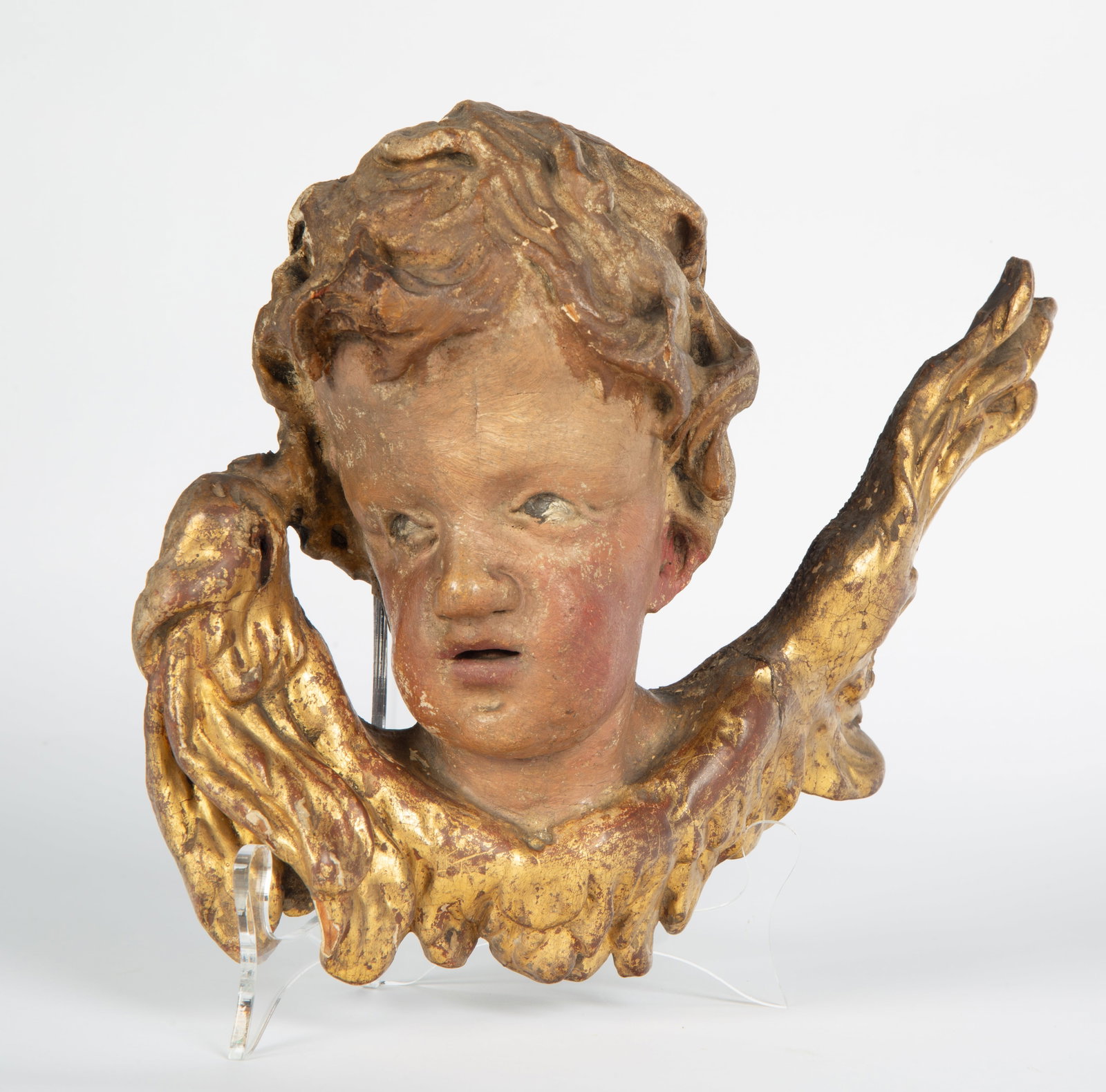 AFTER MEINRAD GUGGENBICHLER (SWISS 1649-1723), 18TH CENTURY: GILT CARVED WOOD PUTTI HEAD SCULPTURE AFTER MEINRAD GUGGENBICHLER (SWISS 1649-1723), 18TH CENTURY dimensions: 23 x 29 cm (9 1/8 x 11 1/2 in.) N.B. Condition reports are available upon request. All lot