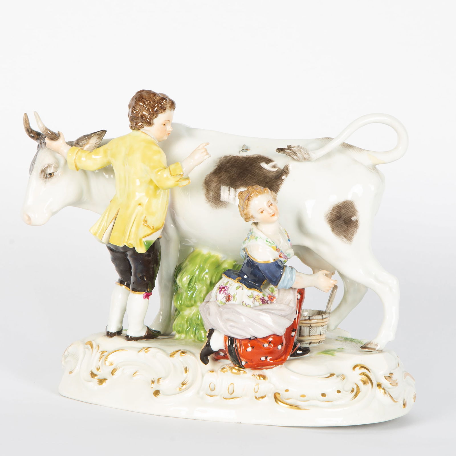 A MEISSEN PORCELAIN FIGURAL GROUP 'BOY AND GIRL MILKING COW': A MEISSEN PORCELAIN FIGURAL GROUP 'BOY AND GIRL MILKING COW' Marked with factory mark in blue underglaze, incised with model no. R79 with numeral 22 stamped in paste, 17 H x 21 W x 13 D cm (6 5/8 H x