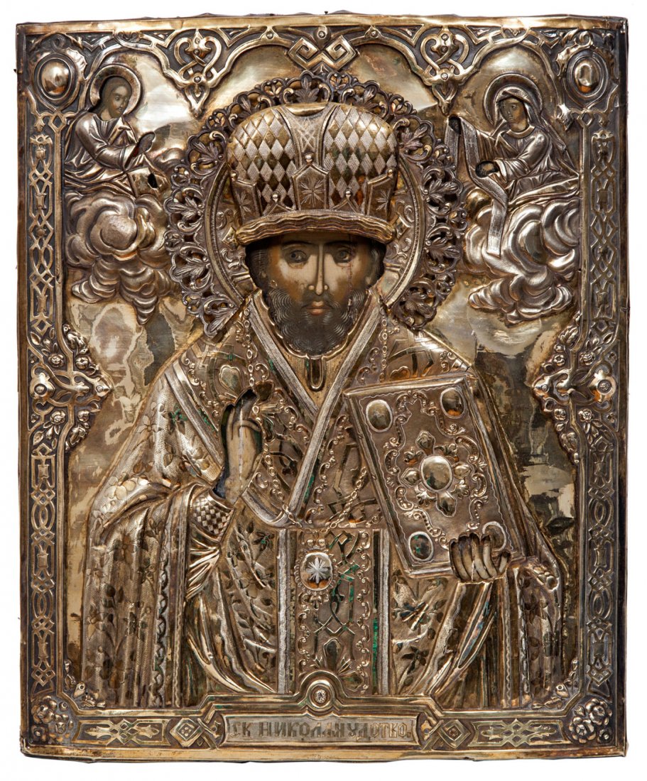 A RUSSIAN ICON OF SAINT NICHOLAS THE WONDERWORKER IN A : A RUSSIAN ICON OF SAINT NICHOLAS THE WONDERWORKER IN A GILT SILVER OKLAD, MOSCOW, CIRCA 1881, the two-toned silver oklad elaborately decorated in repoussé, St. Nicholas depicted in ornate ceremonial 
