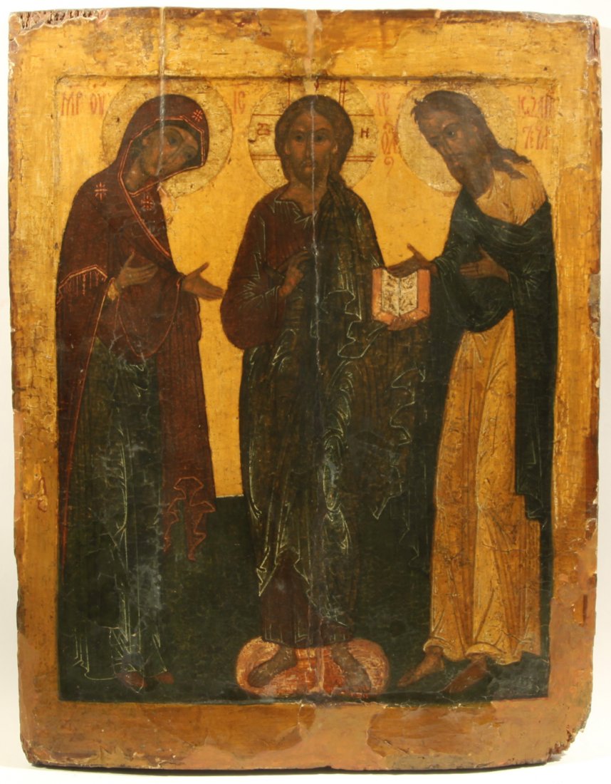 RUSSIAN DEISIS ICON 17TH CENTURY: A RUSSIAN DEISIS ICON WITH THE VIRGIN MARY, JOHN THE BAPTIST, AND CHRIST, 17TH CENTURY, Egg tempera, gold leaf, and gesso on wood panel with a kovcheg. Two insert splints on the back (both missing). 5