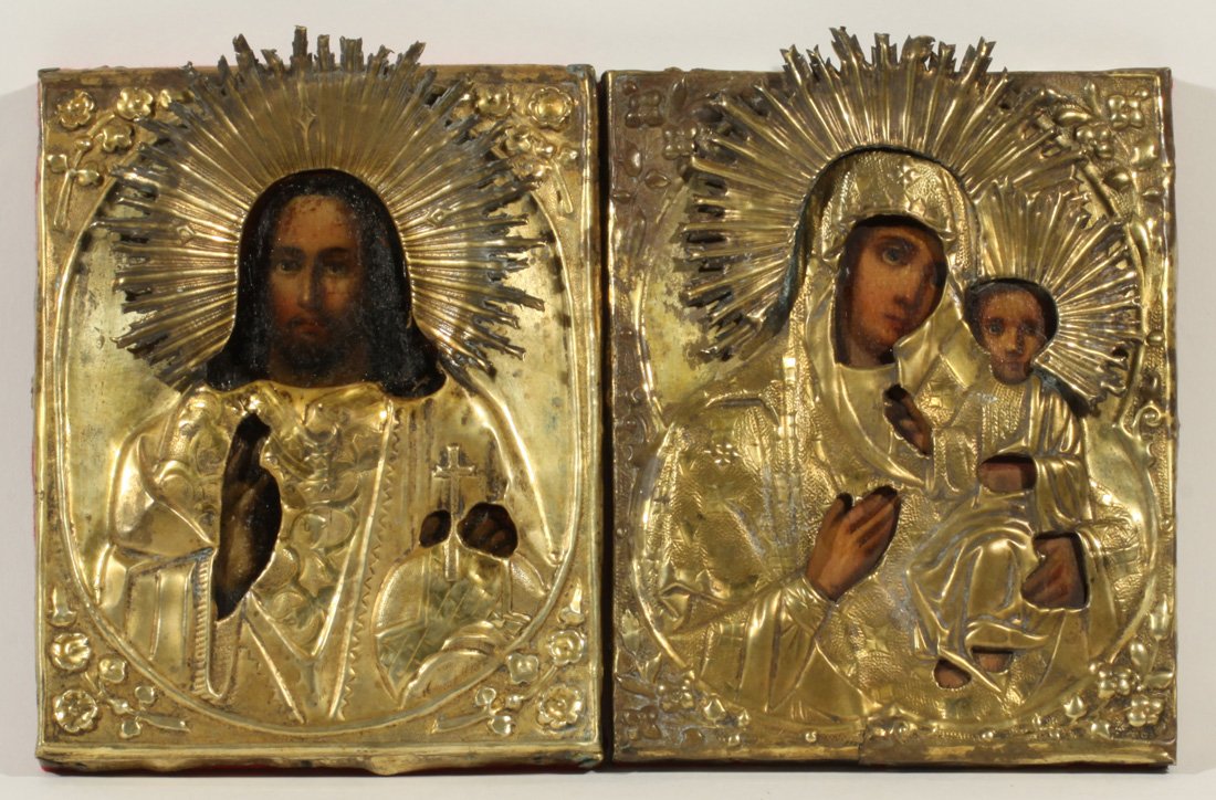 PAIR OF RUSSIAN SILVER MARRIAGE ICONS 1890s: A PAIR OF RUSSIAN MARRIAGE ICONS, 1890S, each with a chased and repousse oklad, the figure of Mother Mary and Jesus with radiating haloes. Egg tempera on panel. 18 x 14.5 (7 1/8 x 5 3/4 in.) each.
