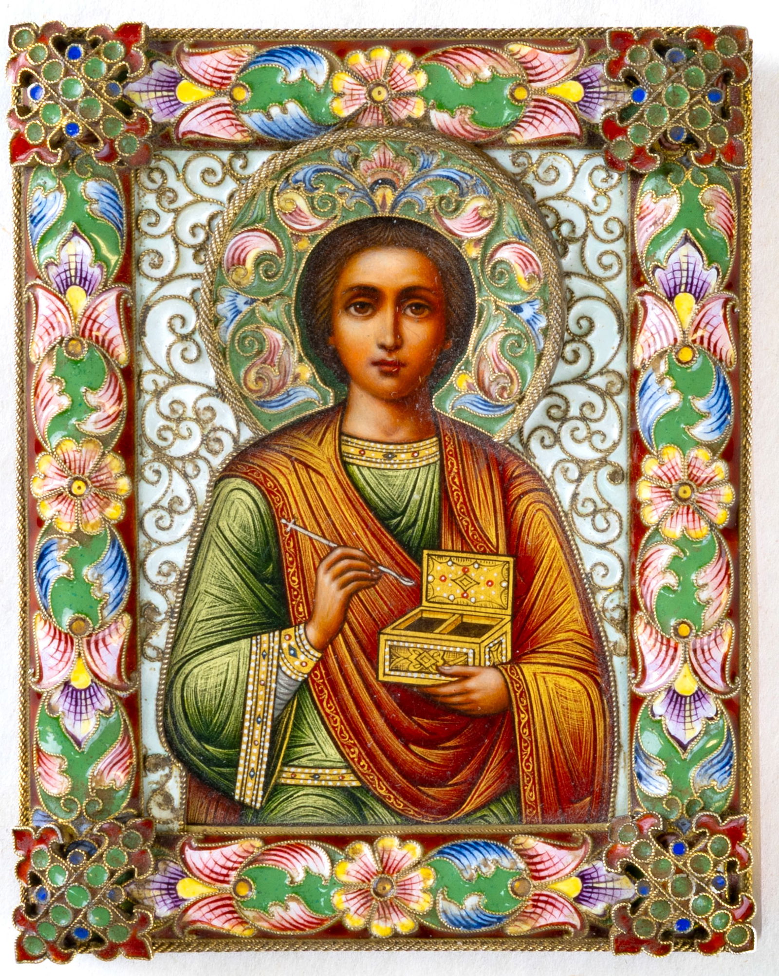 A RUSSIAN GILT SILVER AND CLOISONNE ENAMEL ICON OF SAINT PANTELEIMON THE HEALER, FEODOR RUCKERT,: A RUSSIAN GILT SILVER AND CLOISONNE ENAMEL ICON OF SAINT PANTELEIMON THE HEALER, FEODOR RUCKERT, MOSCOW, 1899-1908 Centered by a finely painted depiction of St. Panteleimon the Healer, shown looking f