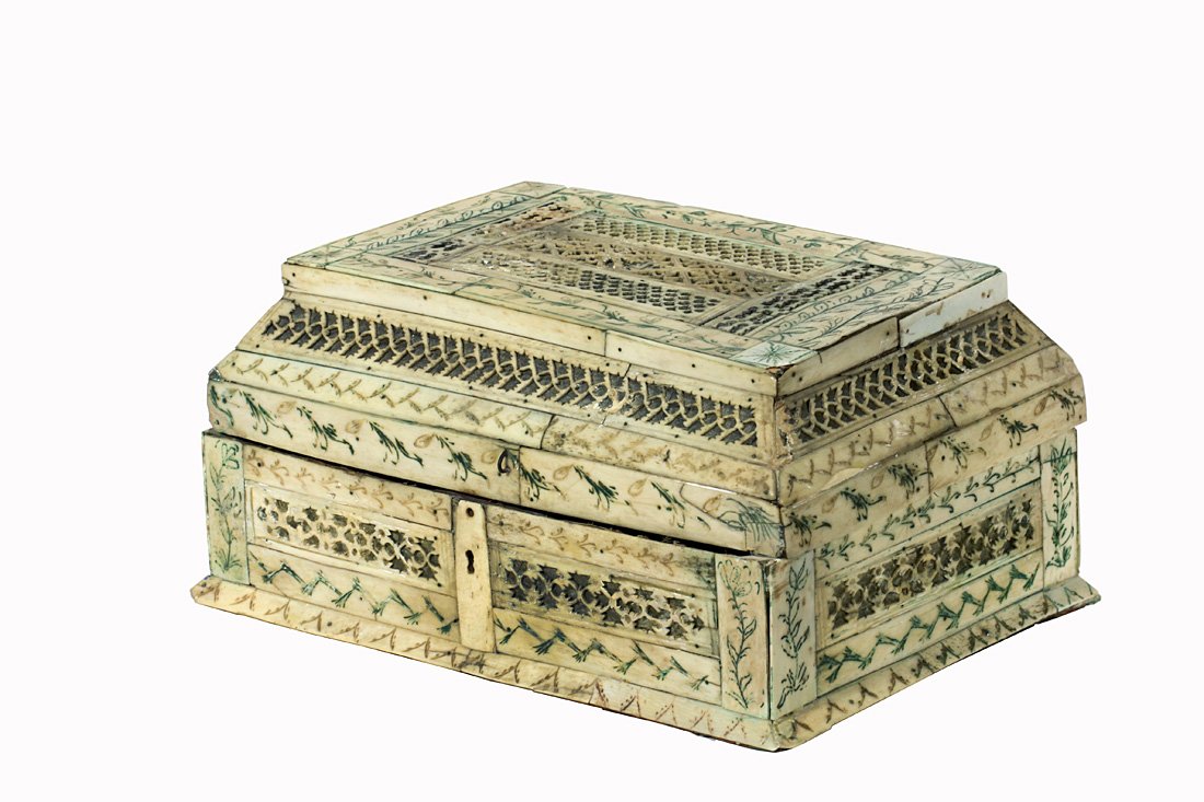 A RUSSIAN WALRUS IVORY AND BONE VENEERED CASKET, MID: A RUSSIAN WALRUS IVORY AND BONE VENEERED CASKET, MID 18TH C., Arkhangelsk, of teremok form, the wood base overlaid with panels of pierced ivory engraved with foliate ornament over yellow metal foil, t