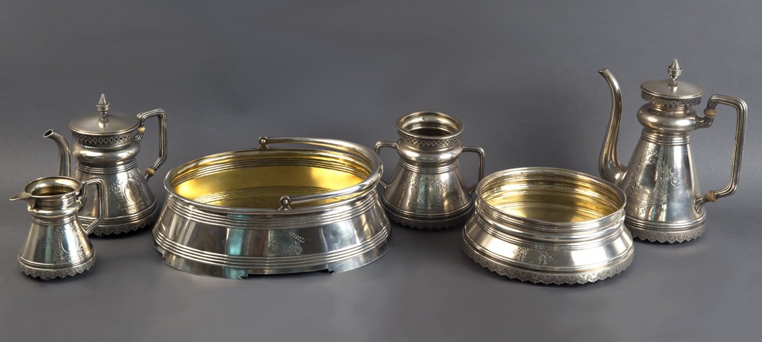 A SIX PIECE RUSSIAN SILVER TEA AND COFFEE SET, FIVE: A SIX PIECE RUSSIAN SILVER TEA AND COFFEE SET, FIVE PIECES MARLED KHLEBNIKOV WITH IMPERIAL WARRANT, ONE MARKED KHLEBNIKOV WITH COAT OF ARMS OF GRAND DUKE KONSTANTIN NIKOLAEVICH, MOSCOW, CIRCA 1876 AND