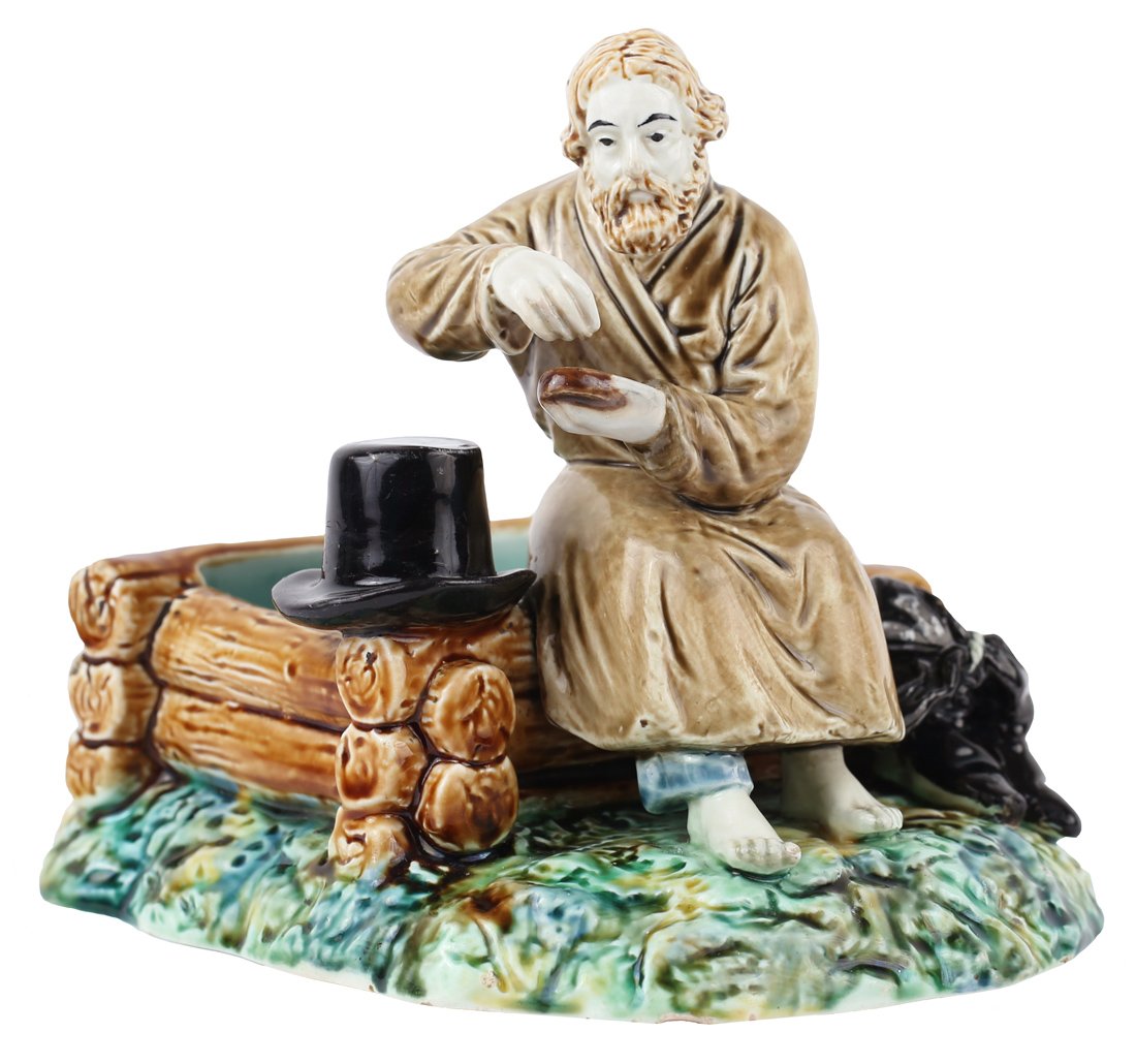 A RUSSIAN FAIENCE FIGURE OF A MAN SALTING BREAD,: A RUSSIAN FAIENCE FIGURE OF A MAN SALTING BREAD, KUZNETSOV MANUFACTORY, MOSCOW, CIRCA 1900, depicting a naturalistically modeled peasant man sitting on the edge of a wooden well, sprinkling a piece of