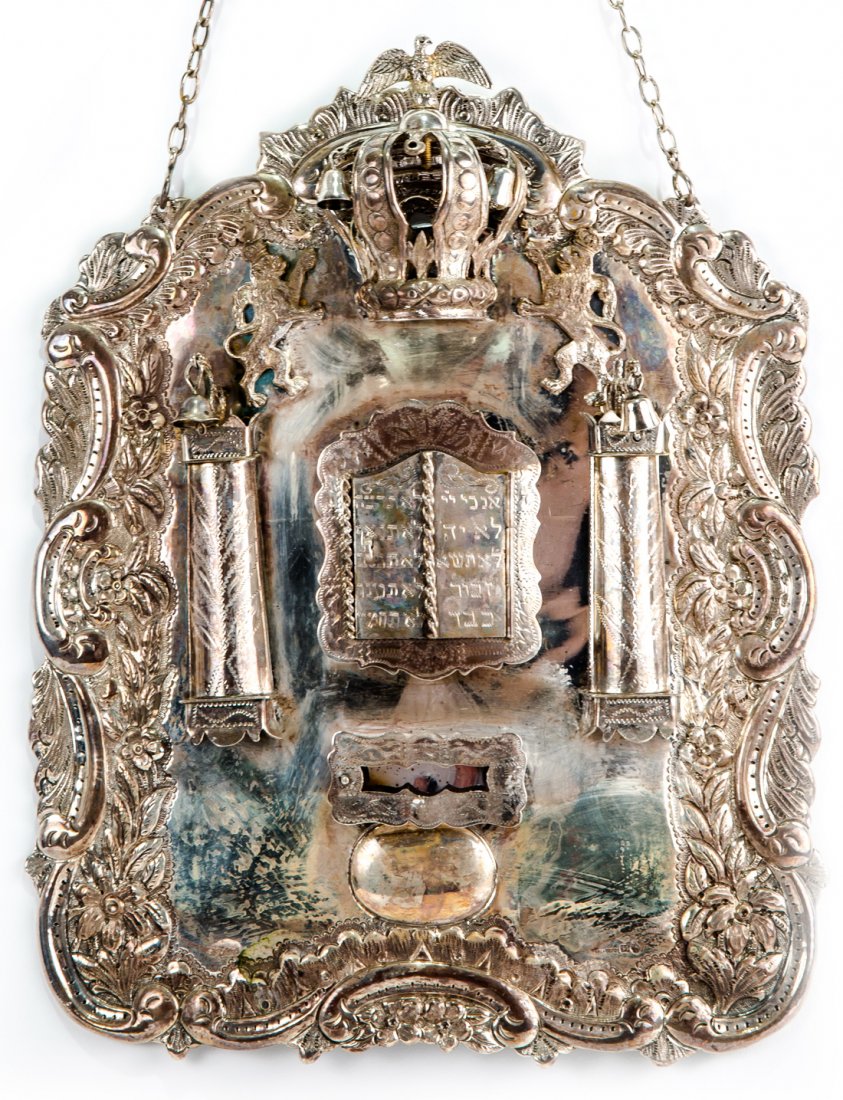 [JUDAICA] A POLISH SILVER TORAH SHIELD, PERLMAN,: [JUDAICA] A POLISH SILVER TORAH SHIELD, PERLMAN, WARSAW, 19TH CENTURY fitted with a compartment containing a miniature Torah scroll, with the doors in the form of the Tables of the Covenant; two colum