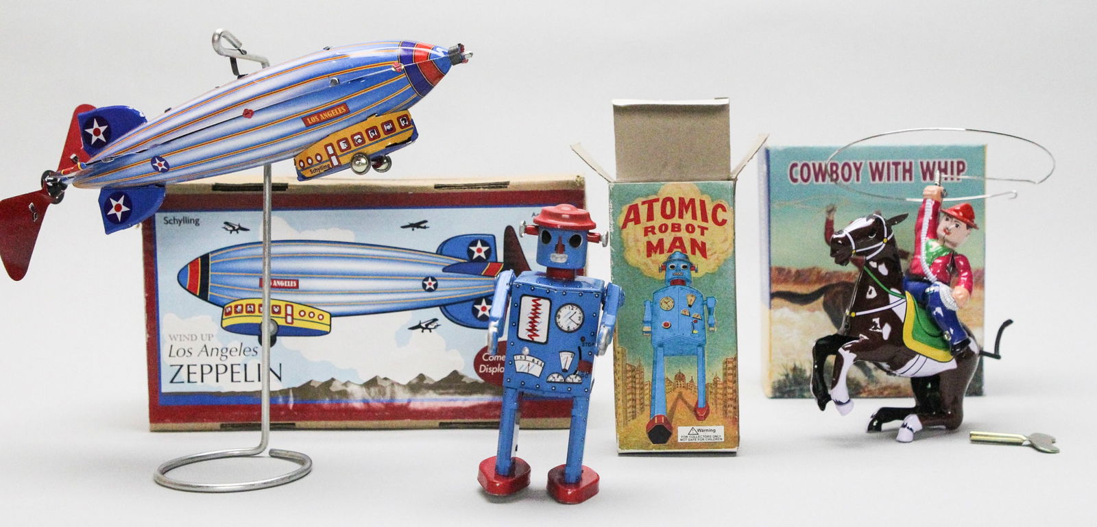 Lot of 3 Toy Figures: 2 Schylling Collector Series: Atomic Robot Man Wind-Up Figure, Wind-Up Los: Lot of 3 Toy Figures: 2 Schylling Collector Series: Atomic Robot Man Wind-Up Figure, Wind-Up Los Angeles Zepellin and Cowboy Figure Zepellin Box Size: H10 x W6 x D4 in. Metal. Wt: 2 lb. This lot conta