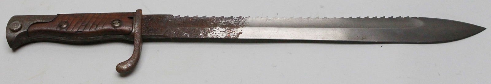 Imperial German Mauser 98/05 Bayonet with Saw back Blade, circa 1905: The Imperial German Mauser 98/05 bayonet with a sawback blade was introduced around 1905 for use with the Gewehr 98 rifle. It features a heavy 14.5-inch steel blade with a distinct bulge toward the po