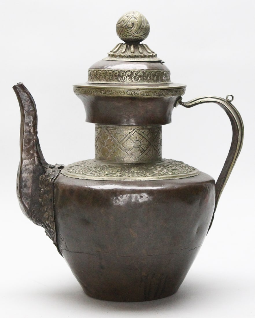 Early 20th Century Tibetan Water Jug: This Early 20th Century Tibetan Water Jug, measuring 14 inches in height and 12 inches in width, is crafted from copper and metal, weighing 5 lbs. It features exquisite craftsmanship, adorned with int