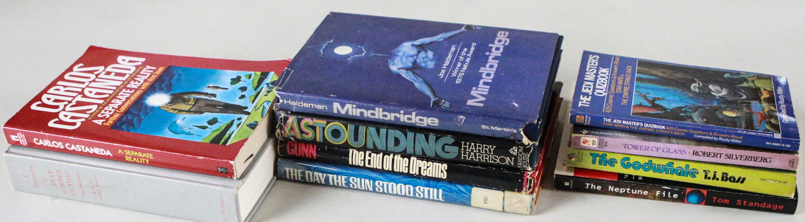 Lot of 10 Science Fiction and Fantasy Books: A diverse lot of ten science fiction and fantasy books, including A Separate Reality by Carlos Castaneda, Mindbridge by Joe Haldeman, Astounding by Harry Harrison, The End of the Dreams by Gunn, The D