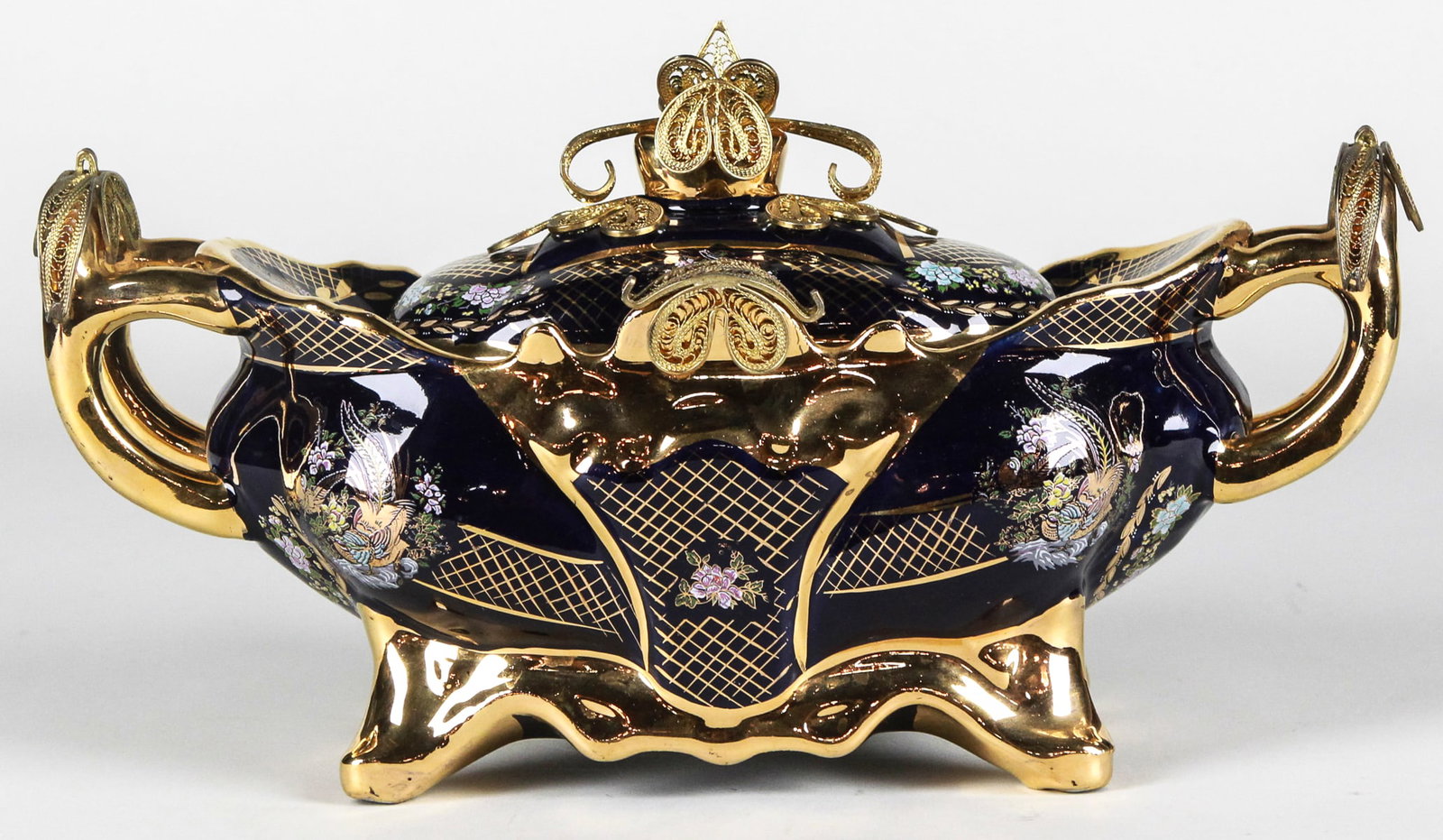 Porsem Lidded Porcelain Vessel with Gold Plating: Striking lidded porcelain vessel by Porsem, made in Turkey, measuring approximately 16 x 6 x 8 inches. This ornate piece features deep cobalt blue glaze with intricate floral and bird motif enamel acc