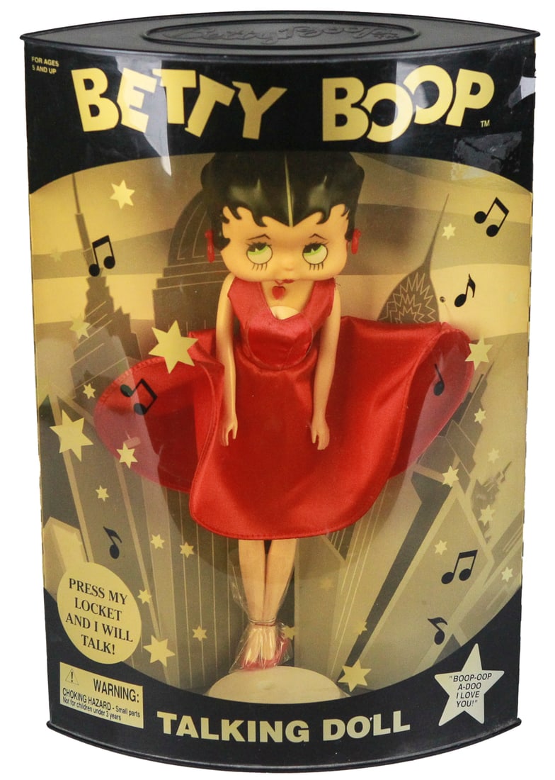 1999 Betty Boop Talking Doll by Precious Kids – Poseable with Original Box (NRFB): This charming 1999 Betty Boop Talking Doll by Precious Kids features the beloved cartoon icon in her signature red dress, with posable arms, bendable legs, and a locket that activates her famous catch