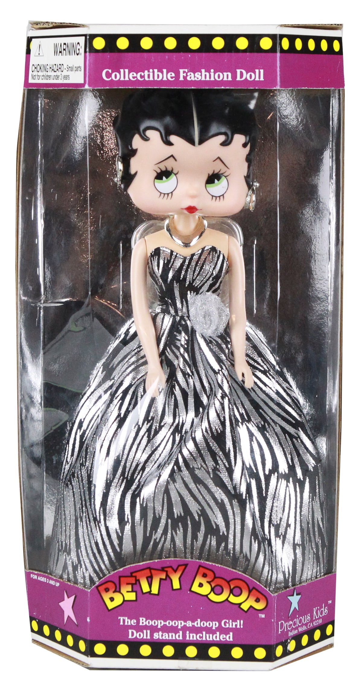 1998 Betty Boop Collectible Fashion Doll by Precious Kids – Zebra Stripe Gown NRFB: This 1998 Betty Boop Collectible Fashion Doll by Precious Kids showcases the beloved animated icon in glamorous style, wearing a dazzling black and silver zebra-striped ball gown accented with a silve