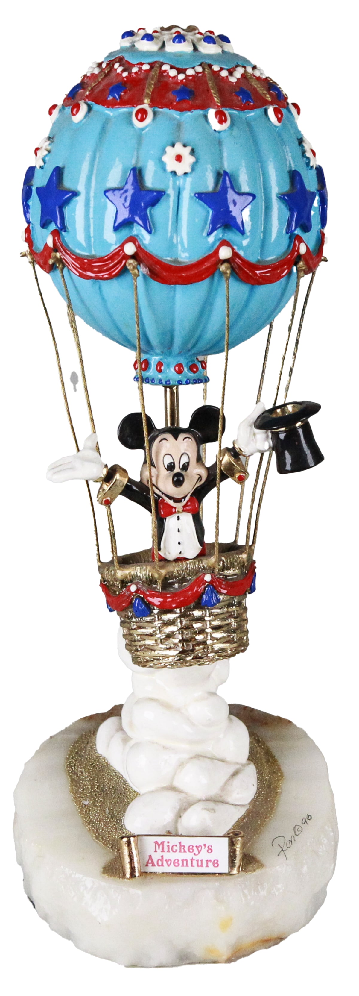 1990 Disney “Mickey’s Adventure” Sculpture by Ron Lee – Limited Edition 954/2750: This vibrant and whimsical sculpture titled Mickey’s Adventure by Ron Lee features Mickey Mouse dressed in formal attire, rising in a patriotic hot air balloon adorned with red, white, and blue star