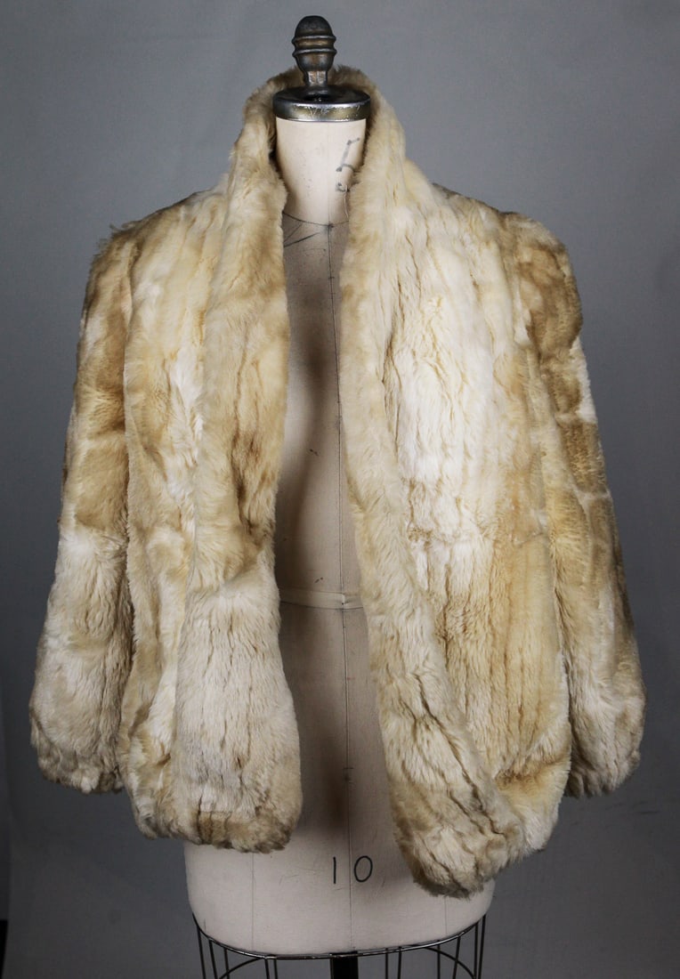 Donnybrook Vintage Women’s Faux Fur Coat: A vintage women's faux fur coat by Donnybrook, made in the U.S.A., featuring a soft cream-toned plush exterior and an open front design. The coat measures approximately 16" from pit to wrist and 19" a