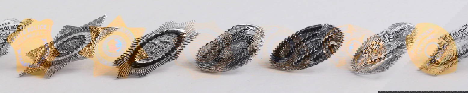 Collection of 6 Vintage Official Police Pins: Set of six vintage police-themed pins representing various U.S. law enforcement departments, including Mass. State Police, Jackson Mississippi, and Blythe Police. These small, detailed pins feature