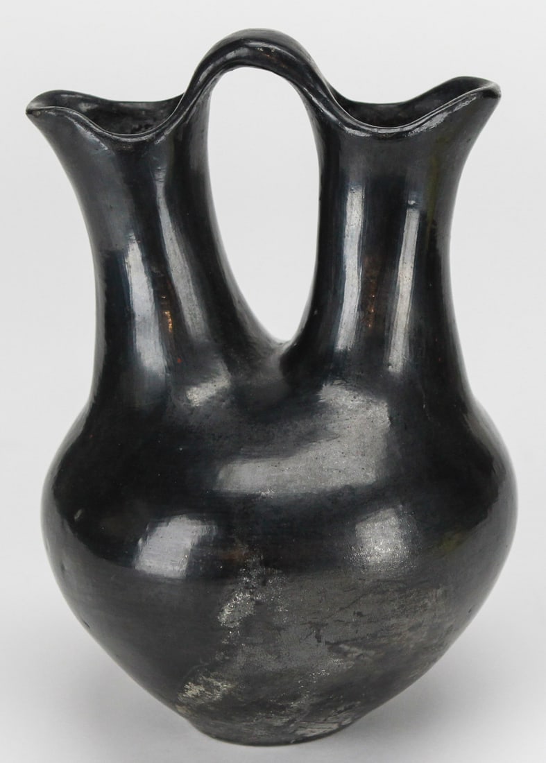 Santa Clara Pueblo Blackware Wedding Vase: This striking blackware wedding vase is a fine example of Santa Clara Pueblo Native American pottery, handcrafted from clay and polished to a rich, dark finish. Standing approximately 11.5 inches tall
