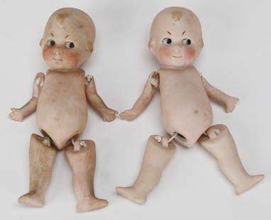 Pair of All-Bisque Porcelain Kewpie-Style Dolls with Jointed Limbs: This delightful pair of vintage all-bisque porcelain dolls, measuring approximately 5.5 x 2 inches each, feature Kewpie-style characteristics with molded tufts of hair, side-glancing eyes, and blush-t