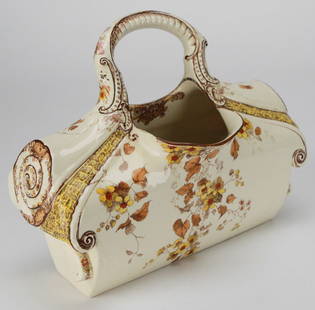 Antique Doulton’s Kew Ceramic Pot with Floral Transfer & Handle – 19th Century British Registry: This ornate ceramic vessel by Doulton’s features the “Kew” pattern with rich floral transfers in warm yellow, rust, and golden brown tones, accented by scrolling relief details and a