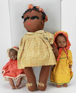 Lot of 3 Vintage African American Dolls, c. 1890 and Later: This charming lot includes three vintage African American dolls, highlighted by a large 18-inch handmade cloth doll circa 1890 dressed in a floral yellow cotton dress with painted facial features and