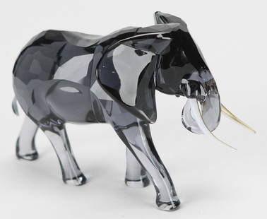Swarovski Crystal “Elegance of Africa” Elephant Bull Figurine with Original Box: This striking Swarovski Crystal “Elegance of Africa” elephant bull figurine showcases remarkable craftsmanship, featuring a faceted smoky-gray crystal body with elongated white tusks, exuding