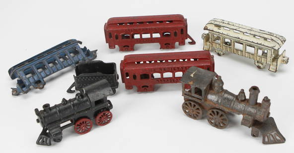 Vintage Metal Toy Train Set – Mixed Cast-Iron Cars & Engines: This charming vintage metal toy train set features a colorful assortment of cast-iron train cars and engines in various conditions, showcasing classic 20th-century toy craftsmanship. The collection in