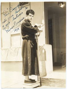 1939 Ramon Novarro Signed Photograph in Robe on Scale (PSA/DNA Certified): Offered here is a charming 9.25 x 7 in. vintage photograph of legendary Mexican-American silent film star Ramon Novarro, captured in 1939 casually dressed in a robe while weighing himself on a scale.