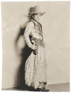 1926 Tom Mix Cowboy Portrait – Original William Fox Photoplay Photograph with COA: This original 1926 photographic portrait features legendary silent film cowboy star Tom Mix in full Western regalia, including his iconic oversized hat, fringed chaps, and pistol belt, striking a