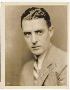 John Gilbert Signed MGM Portrait – La Bohème Era Promo with Typed Bio: This original 10.25 x 8-inch sepia-toned studio portrait features silent film icon John Gilbert in a formal pose, boldly signed in ink across the lower portion of the image. Created during his work on