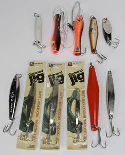 Lot of 10 Miscellaneous Fishing Lures and Hooks: A mixed lot of 10 fishing lures and hooks, including a variety of styles and brands such as Diamond Jig and assorted spoons and plugs. Some lures are in original packaging, while others show minor use