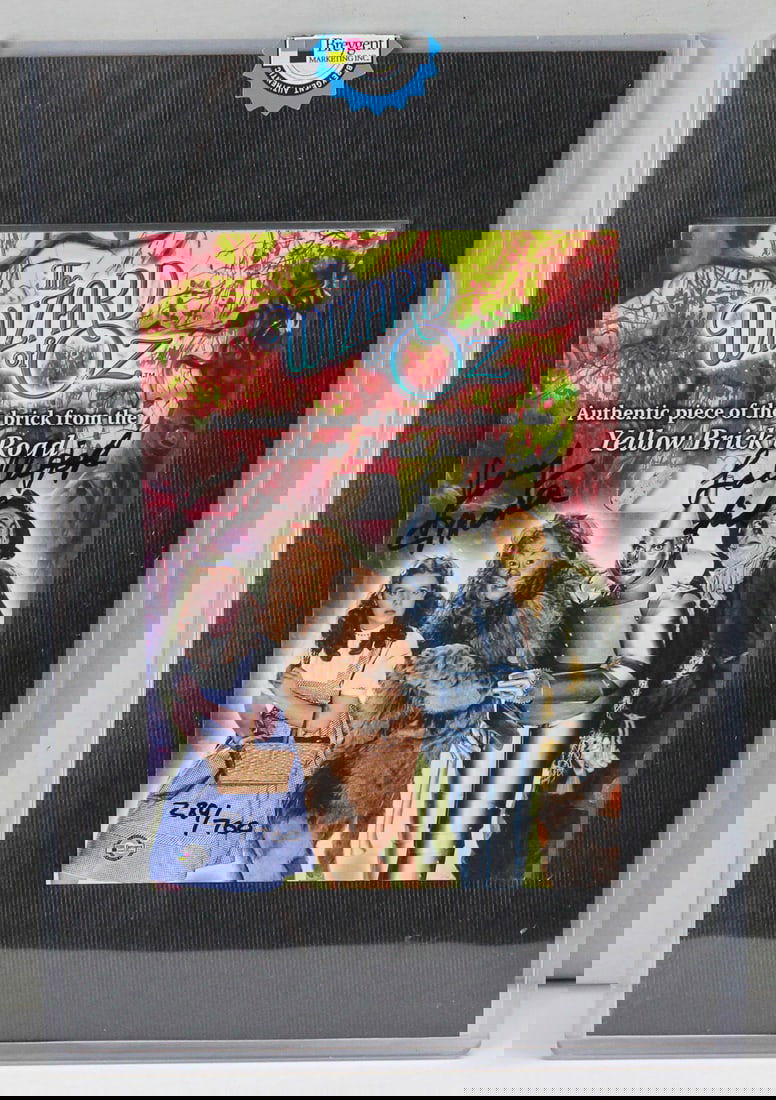 Wizard of Oz Yellow Brick Road Relic with Jerry Maren Signature (#289/700): This unique collector’s item features an authentic piece of the iconic Yellow Brick Road from the 1939 film The Wizard of Oz, encapsulated in a colorful commemorative card. Limited edition #289 of 7