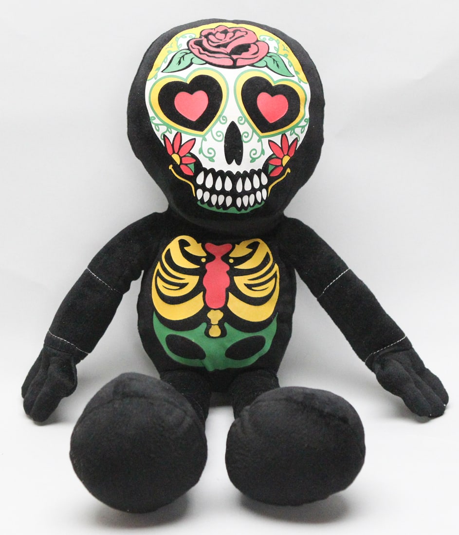 Fiesta Toys Día de los Muertos Plush Figure: This vibrant Fiesta Toys Día de los Muertos plush figure measures approximately 26 inches tall and features a colorful calavera (sugar skull) face design with heart eyes, floral accents, and stylized