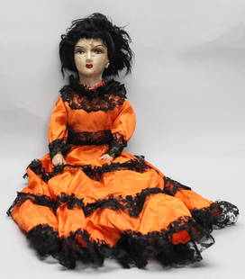 Vintage 1800s Spanish Porcelain Doll ā 29": Striking 29-inch vintage Spanish doll from the 1800s, crafted with a painted porcelain head and hands, wearing an elaborate orange satin gown adorned with black lace and red beaded necklace. The doll