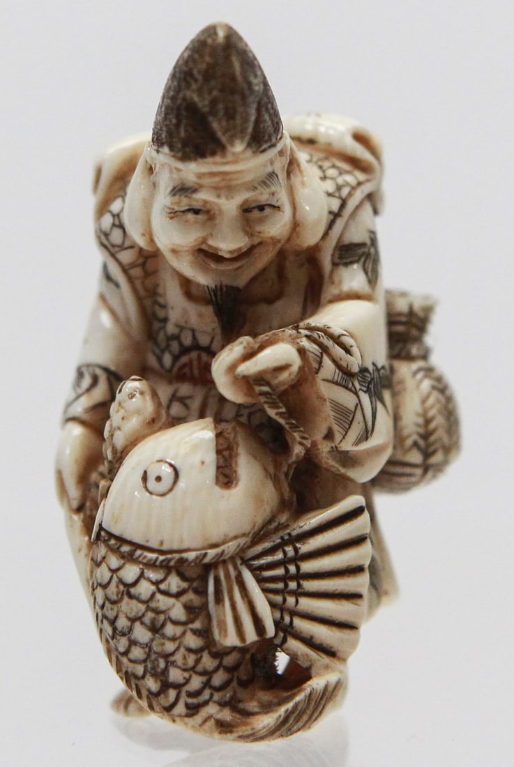 Vintage Japanese Fisherman Netsuke with Carp Fish: Vintage Japanese netsuke depicting a smiling fisherman or elder carrying a large carp while wearing a traditional robe decorated with finely engraved bamboo, geometric, and longevity motifs. The figur