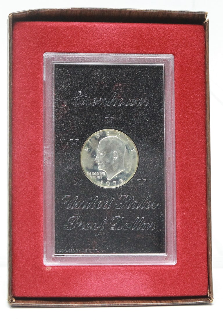 1973 Eisenhower United States Proof Dollar in Original Government Presentation Box: Original 1973 United States Proof Eisenhower Dollar housed in its original U.S. Mint hard plastic holder with black insert and complete government presentation box featuring a faux wood finish and