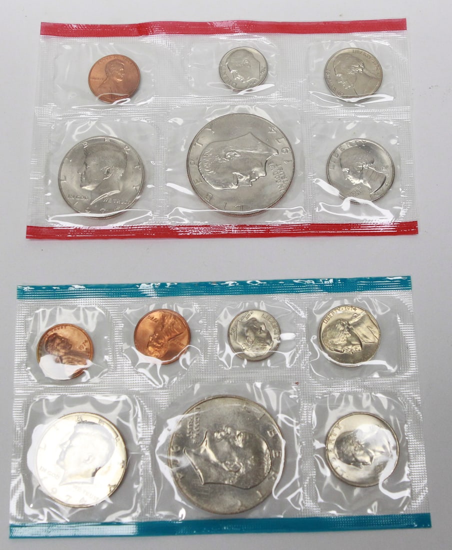 1974 U.S. Mint Uncirculated Coin Set: Original 1974 United States Mint Uncirculated Coin Set comprised of both Philadelphia (red seal) and Denver (blue seal) mint cellophane packs. The set includes the Kennedy half dollar, Washington quar
