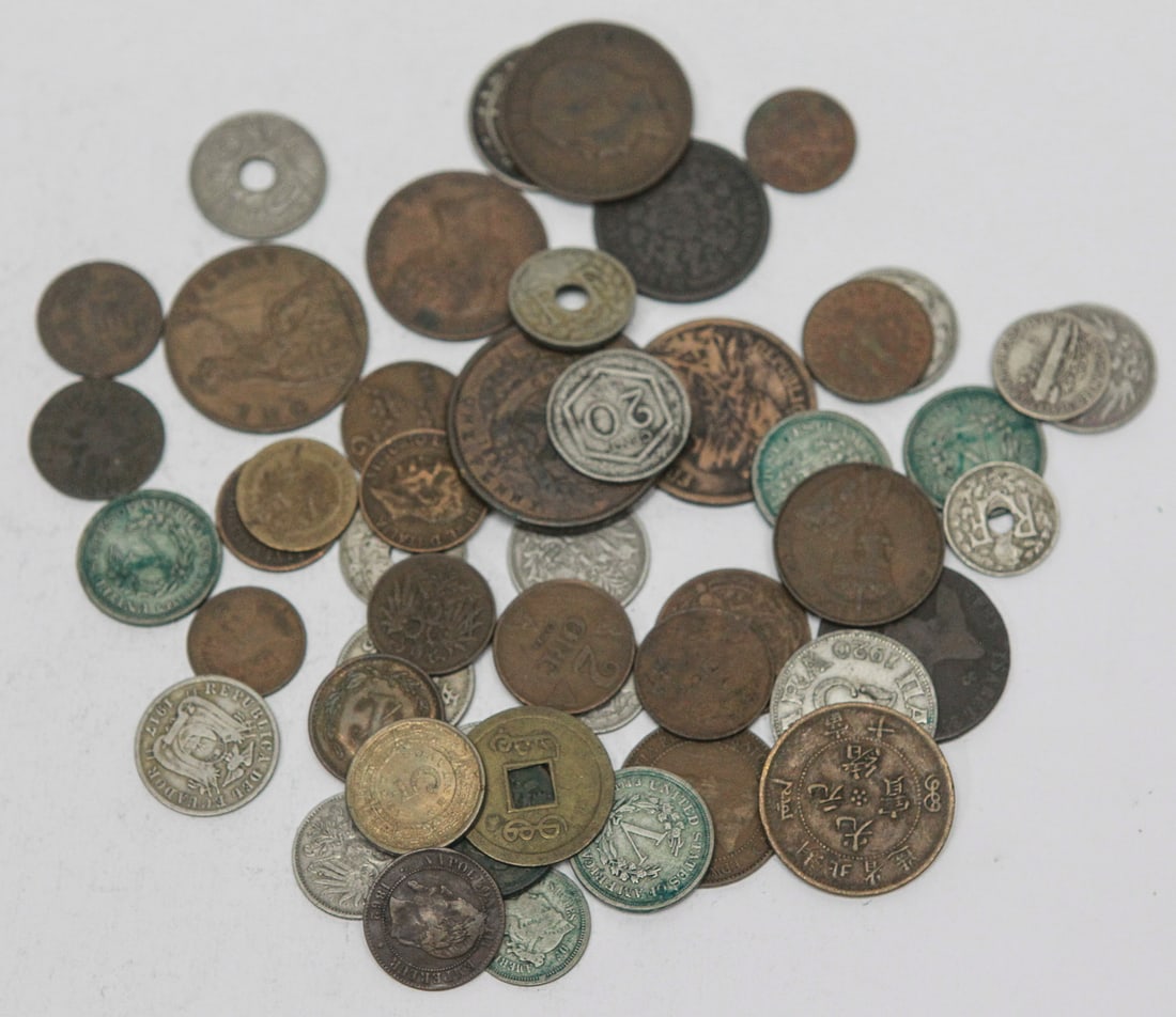 Lot of 50 Assorted World Coins, Foreign Currency, and Tokens: Lot of approximately 50 assorted world coins and tokens representing a wide variety of countries and eras. The group includes coins from Asia, Europe, and the Americas, featuring copper, bronze,