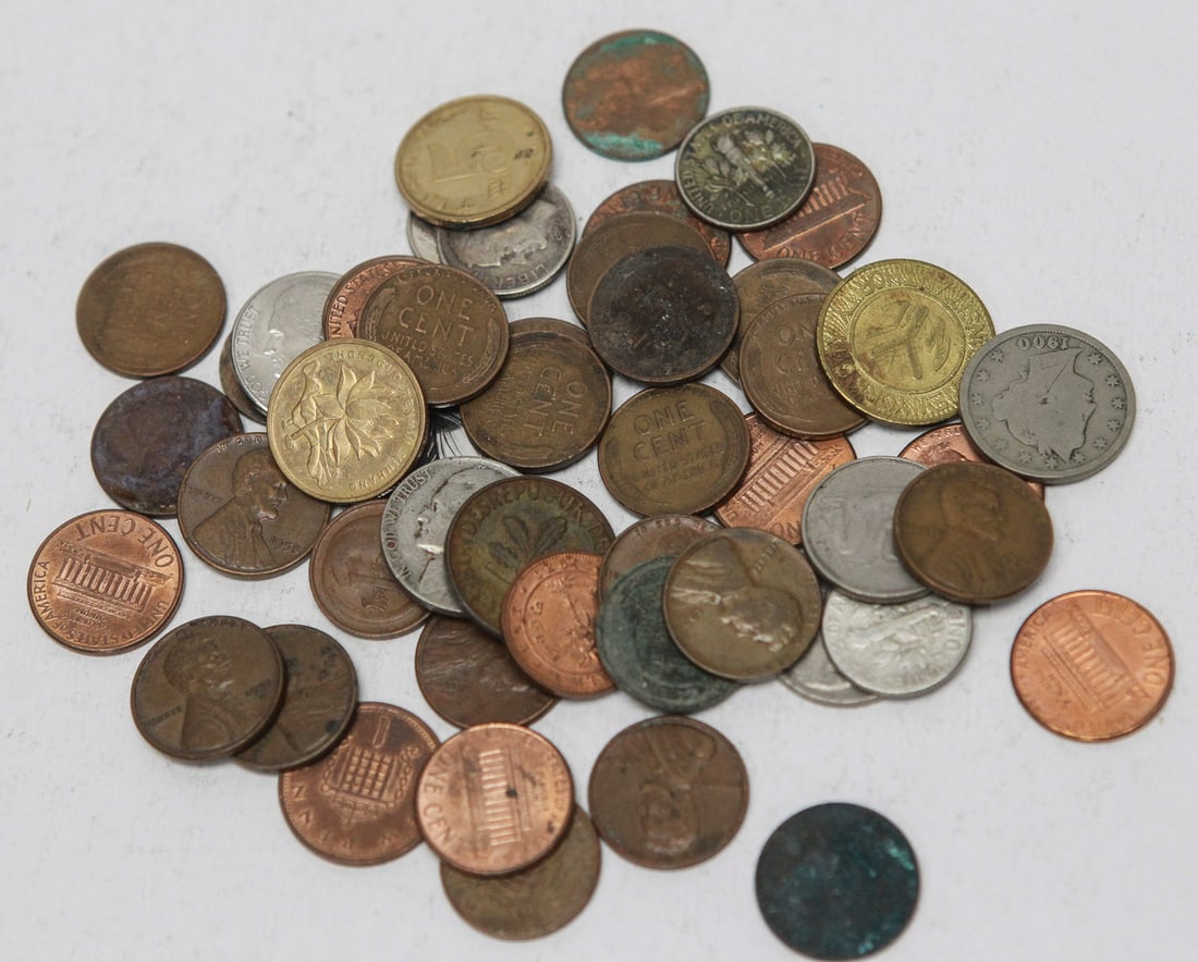 Lot of 50 Assorted World Coins: Lot of approximately 50 assorted coins featuring a mix of United States and world issues from various countries and decades. The group includes Lincoln cents, Jefferson nickels, foreign bronze,