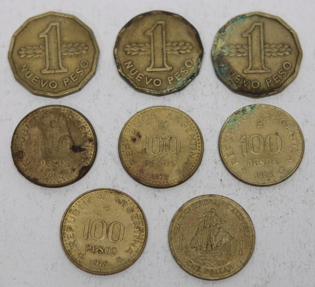 Lot of 8 World Coins: Collection of eight assorted world coins featuring three Uruguay 1 Nuevo Peso coins (1976–1978), four Argentina 100 Peso and 100 Pesos coins dated 1978–1980 honoring General José de San Martín,