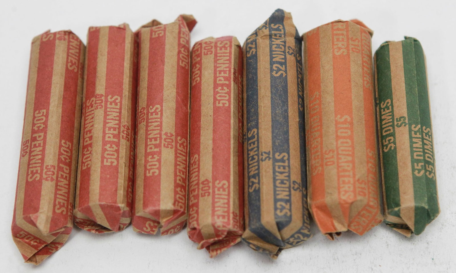 Mixed Lot of Unopened U.S. Coin Rolls: Collection of unopened U.S. bank-wrapped coin rolls including penny, nickel, quarter, and dime denominations. The lot appears to include five penny rolls, one nickel roll, one quarter roll, and one