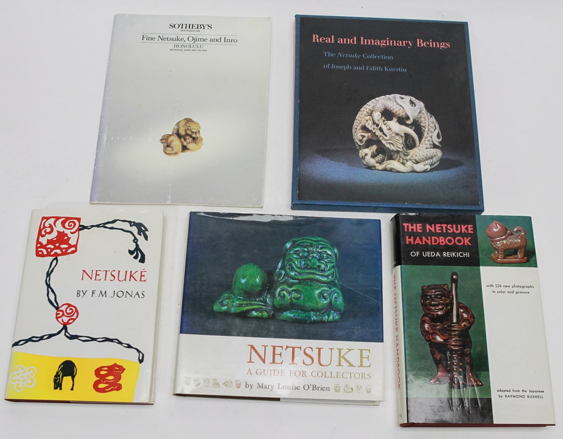 Lot of 5 Netsuke Reference Books Including Sotheby's Catalogs: Collection of five books and reference works devoted to Japanese netsuke, featuring collector guides, museum-quality photography, and auction references. Included are The Netsuke Handbook by Ueda Reik