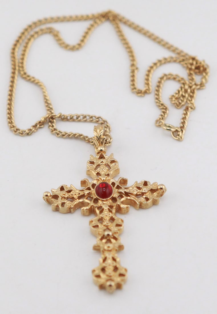 Avon Gold-Tone Cross Pendant Necklace with Red Cabochon Accent: Vintage Avon gold-tone cross pendant necklace featuring an ornate openwork cross design centered with a round red cabochon accent. The pendant measures approximately 3 x 2 inches and is suspended from