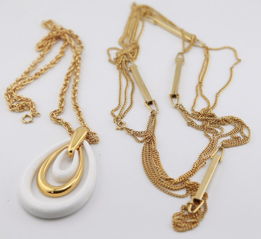 Trifari White Lucite Pendant Necklace: Vintage Trifari gold-tone pendant necklace featuring a large white Lucite teardrop-form pendant accented with a polished gold-tone open teardrop element. The pendant measures approximately 3 x 2 inche