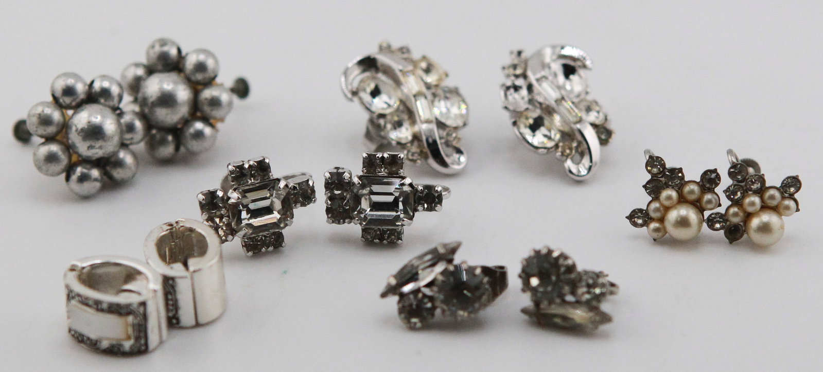 Lot of 7 Pairs of Vintage Rhinestone & Silver-Tone Earrings: Collection of seven pairs of vintage fashion earrings in silver-tone finishes, including sparkling clear rhinestone clip-ons, faux pearl and rhinestone cluster screw-back earrings, silver-tone bead cl
