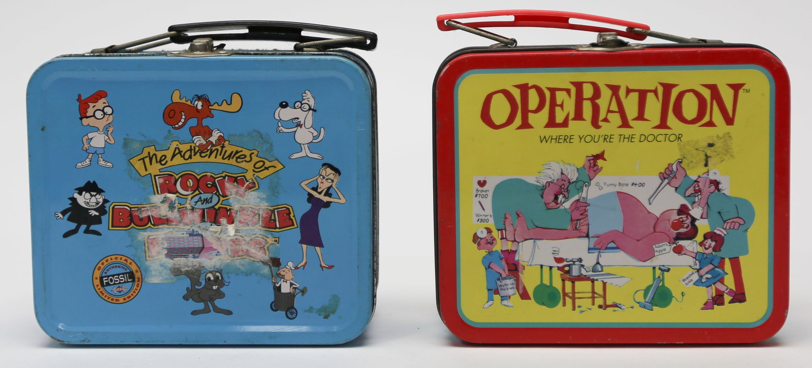 Lot of Two Character Tin Lunch Boxes: A lot of two miniature metal lunch boxes featuring The Adventures of Rocky and Bullwinkle and Friends by Fossil and the classic Operation board game. Each box has colorful printed decoration, a hinged