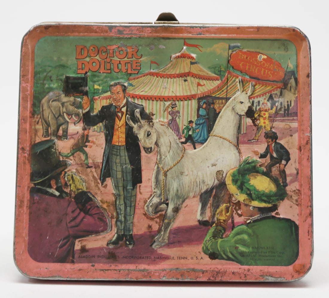 1967 Doctor Dolittle Aladdin Metal Lunch Box: A vintage 1967 Aladdin Industries metal lunch box featuring colorful scenes from the Doctor Dolittle film, including Rex Harrison, circus animals, and the giant sea snail. Measures approximately 7 x 8