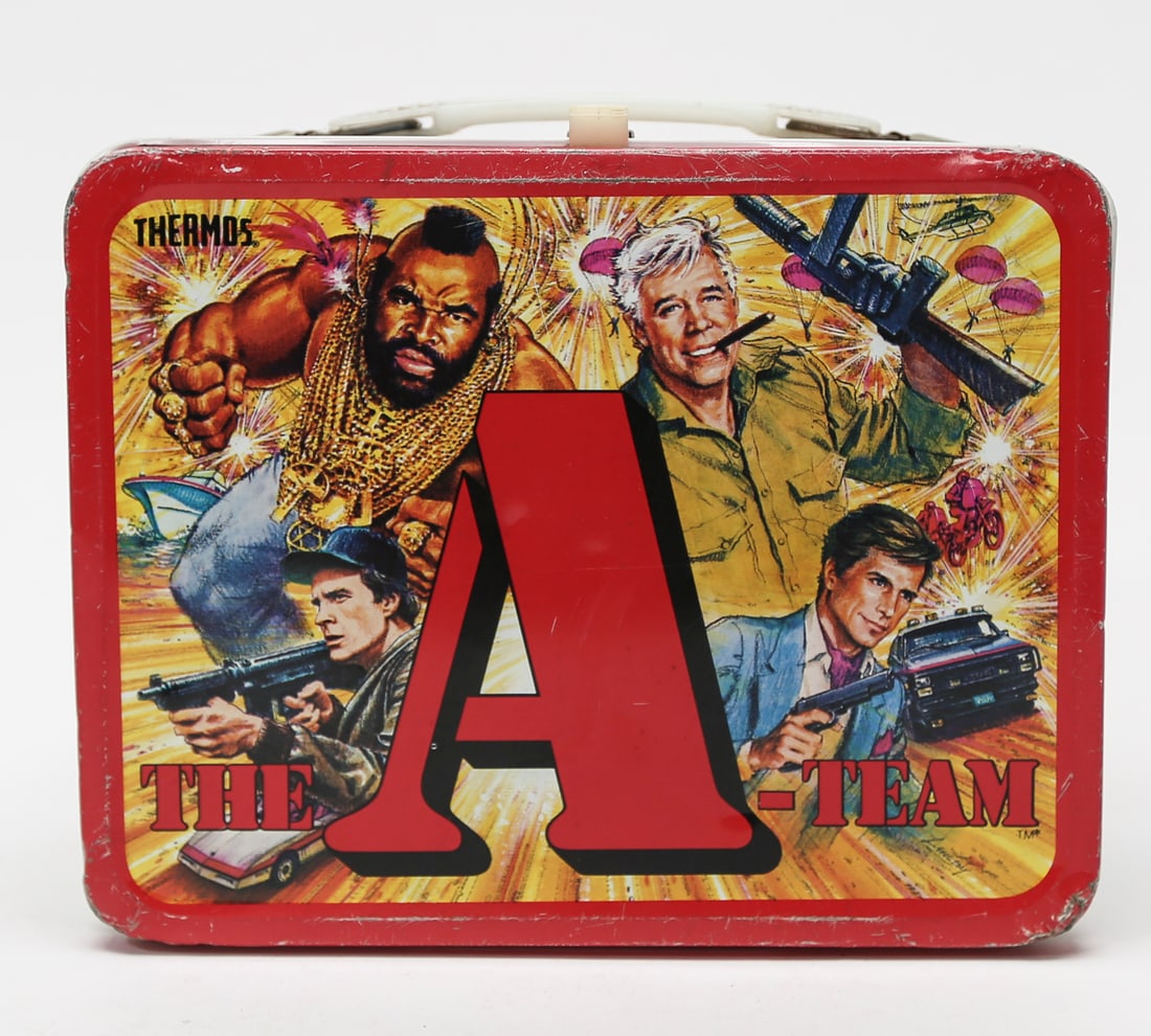 1983 The A-Team Thermos Metal Lunch Box with Thermos: A vintage 1983 Thermos metal lunch box featuring characters and action scenes from The A-Team television series, including B.A. Baracus, Hannibal, Face, and Murdock. The red lunch box measures approxi