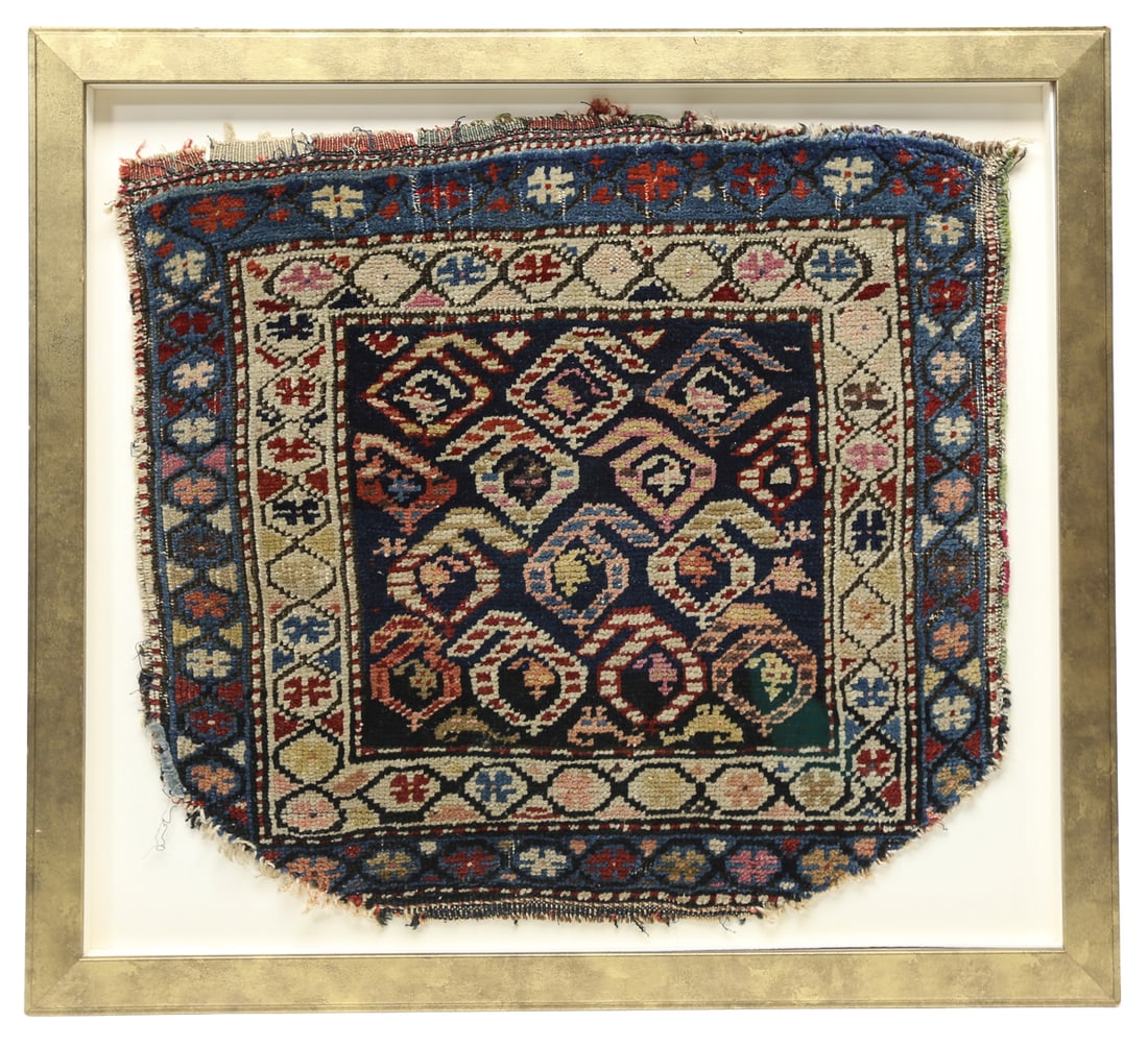 Framed Antique Armenian Handmade Wool Rug Fragment: Antique Armenian hand-knotted wool rug fragment featuring a dark central field filled with colorful geometric floral motifs and multiple decorative borders in blue, ivory, red, pink, and green. Presen