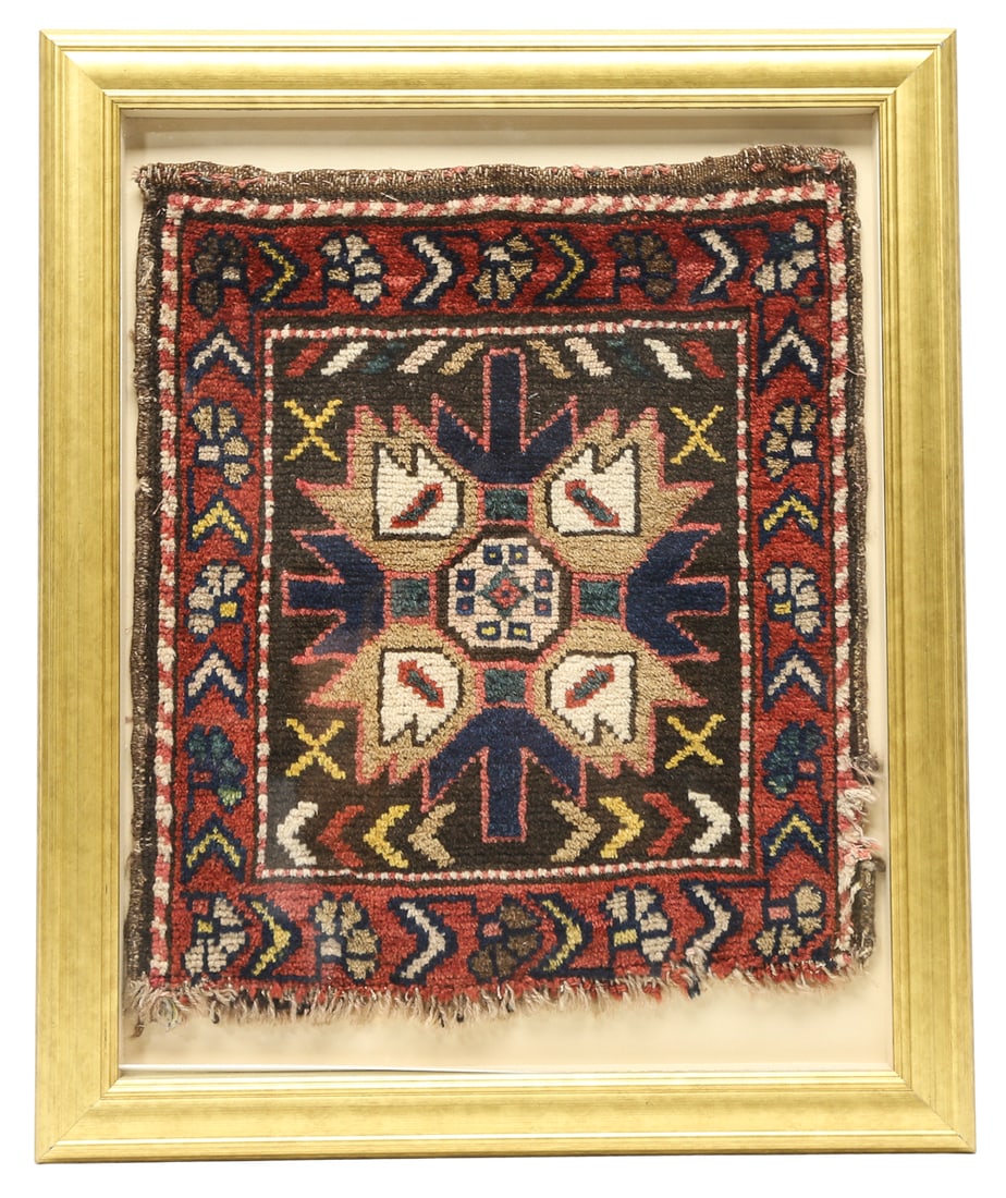 Framed Antique Armenian Handmade Wool Rug Fragment: Antique Armenian hand-knotted wool rug fragment featuring a central geometric medallion with stylized floral motifs, surrounded by a decorative border in red, brown, blue, ivory, yellow, and green. Pr